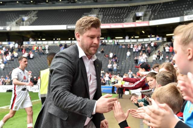 Karl Robinson has signed more autographs than players this summer