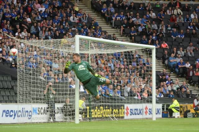 Everton keeper Maarten Stekelenburg makes sure Ed Upson's free kick goes wide.