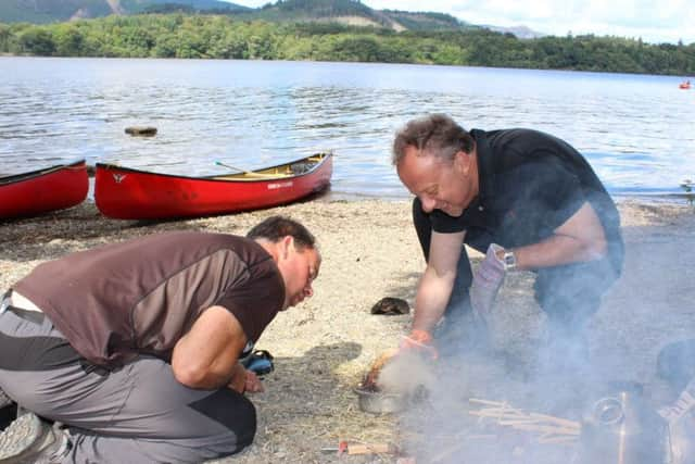 Chris gets a helping hand making a fire.