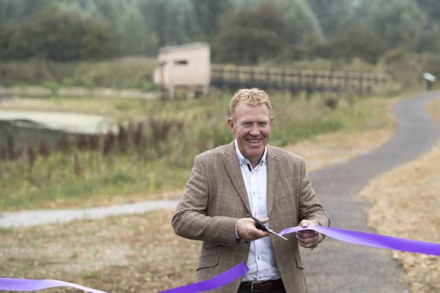 Adam Henson cuts the ribbon at the opening of the reserve