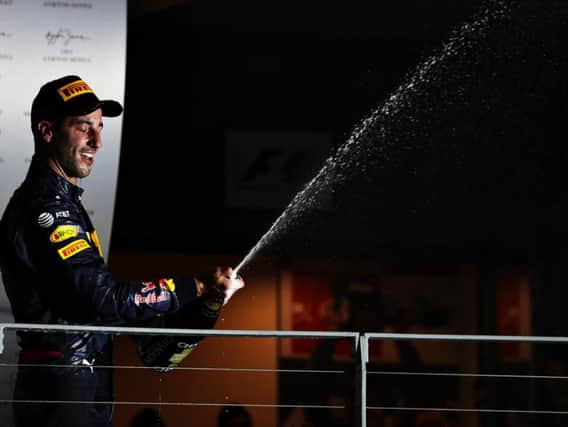 Daniel Ricciardo sprays the champagne on the podium in Singapore