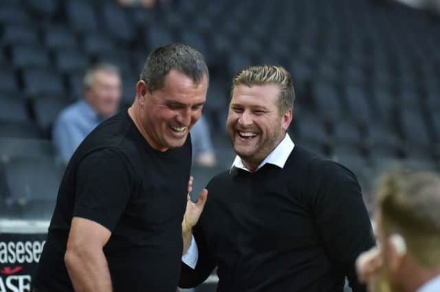 Karl Robinson shares a laugh with Barnet boss Martin Allen