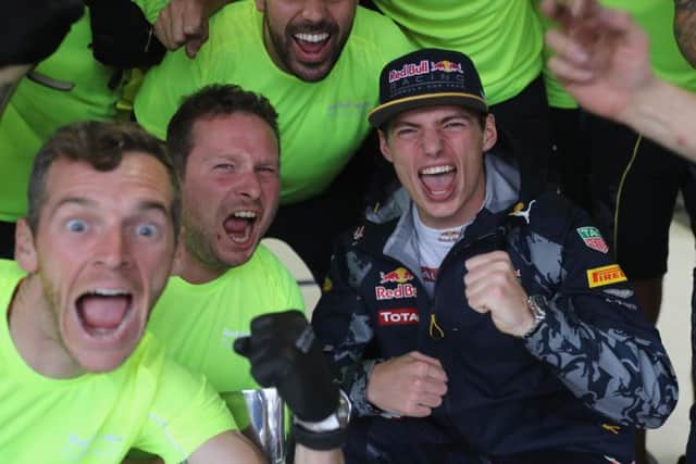 Verstappen celebrates with his team.