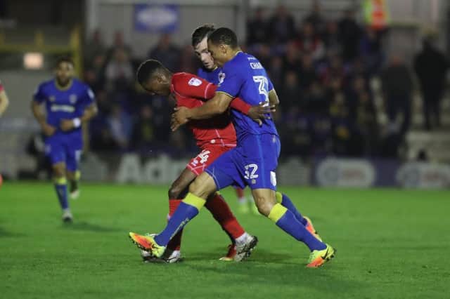 AFC Wimbledon defender Darius Charles (32) closes down MK Dons striker Kieran Agard (14) during the EFL Sky Bet League 1 match between AFC Wimbledon and Milton Keynes Dons at the Cherry Red Records Stadium, Kingston, England on 14 March 2017. Photo by Stuart Butcher. PSI-3498-0010