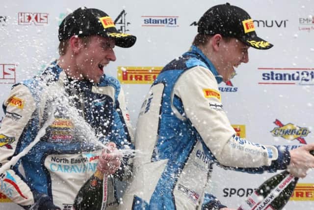 Will Tregurtha, right, celebrates on the podium