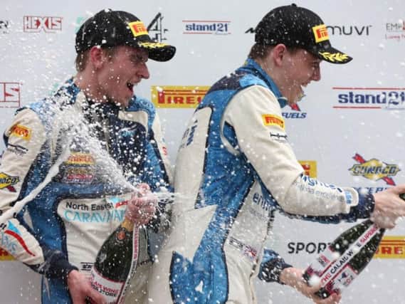 Will Tregurtha, right, celebrates on the podium
