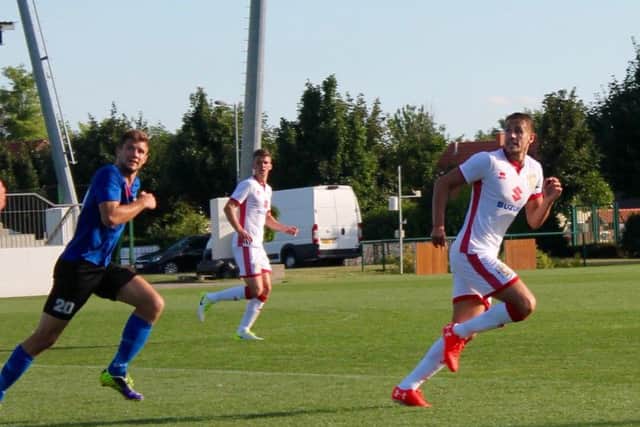 Scott Wootton back in action in Hungary. Pic: MKDons.com