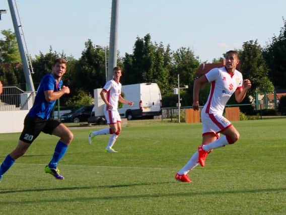 Scott Wootton back in action in Hungary. Pic: MKDons.com