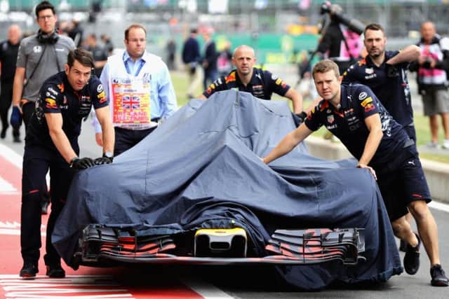 Daniel Ricciardo's car is wheeled back into the pits