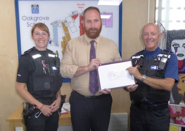 Thames Valley Police present a cheque to Oakgrove School