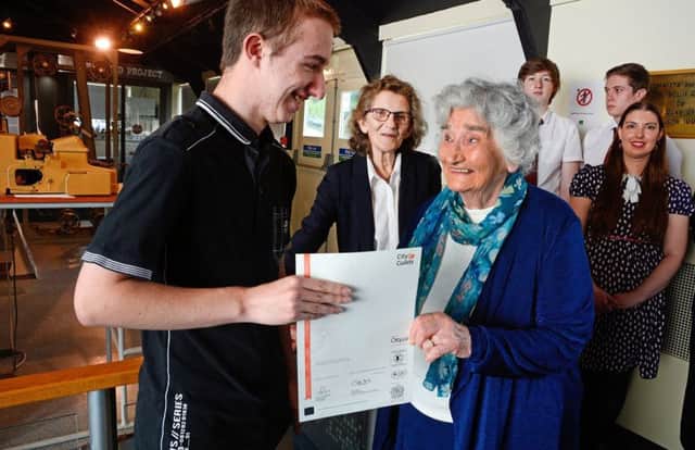 Aaron Revell,(17), receiving his cerificate from former codebreaker Irene Dixon,(93), at TNMOC, Bletchley Park, 5th September 2017.Photos by John Robertson.